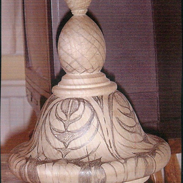Section shows design of acanthus leaf on finial