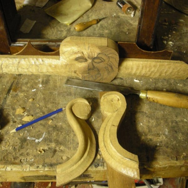 Longcase clock hood with lion detailing